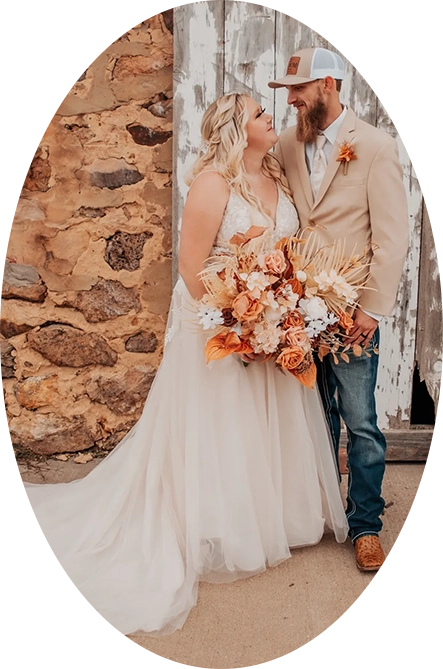 A bride and groom standing next to each other.