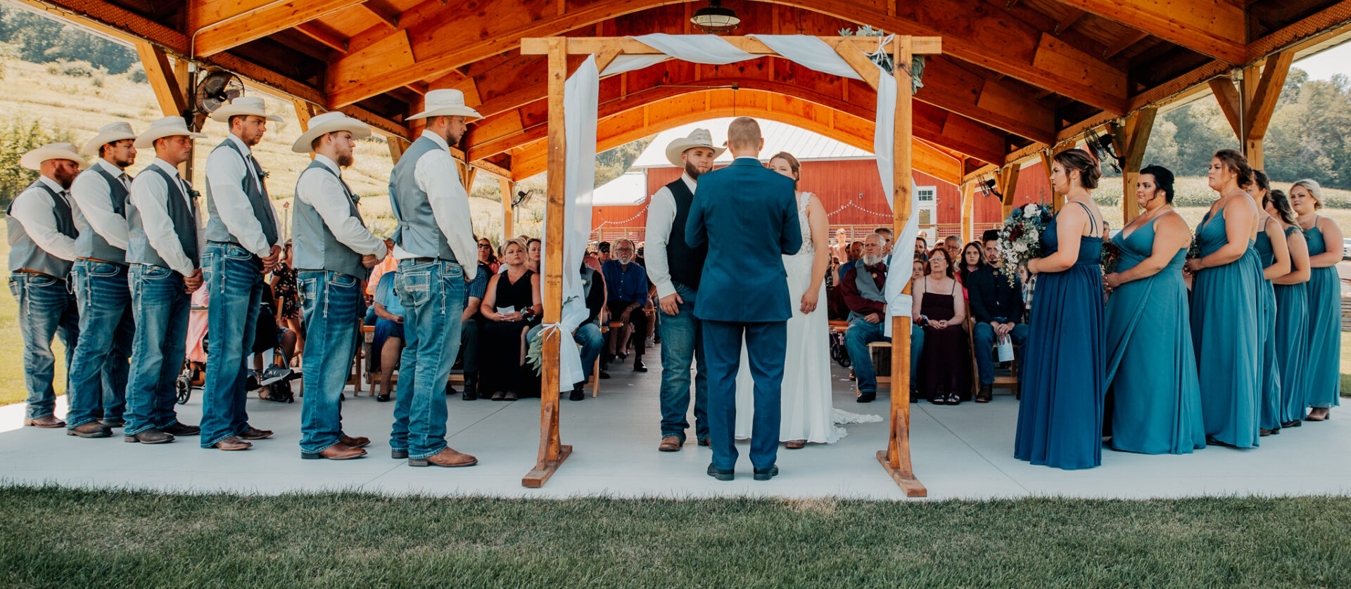 A couple getting married under an arbour.