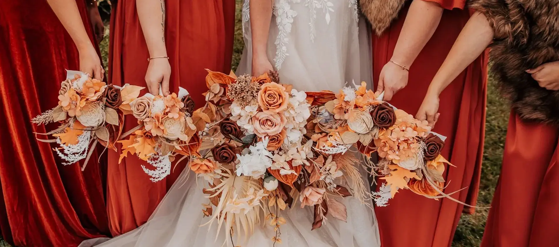 A bride and her bridesmaids holding their bouquet.