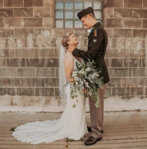 A military couple posing for their wedding picture.