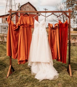 A wedding dress hanging on a clothes rack.