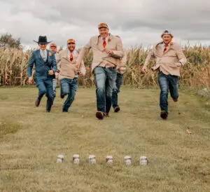 A group of men running in the grass.