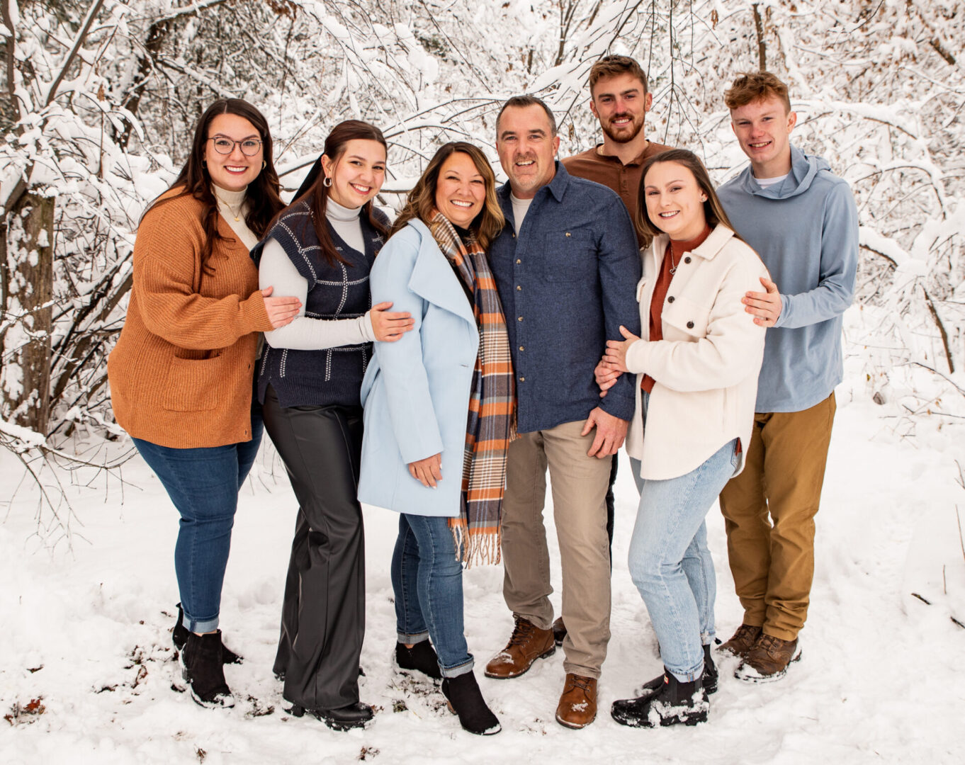 A group of people standing in the snow.