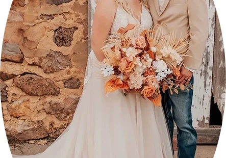 A bride and groom standing next to each other.